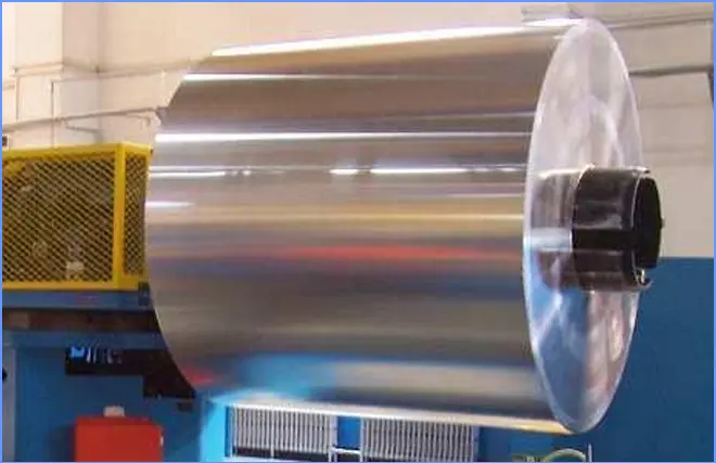 Bobina de aluminio instalada en el desbobinador al inicio del proceso de fabricación de latas de aluminio