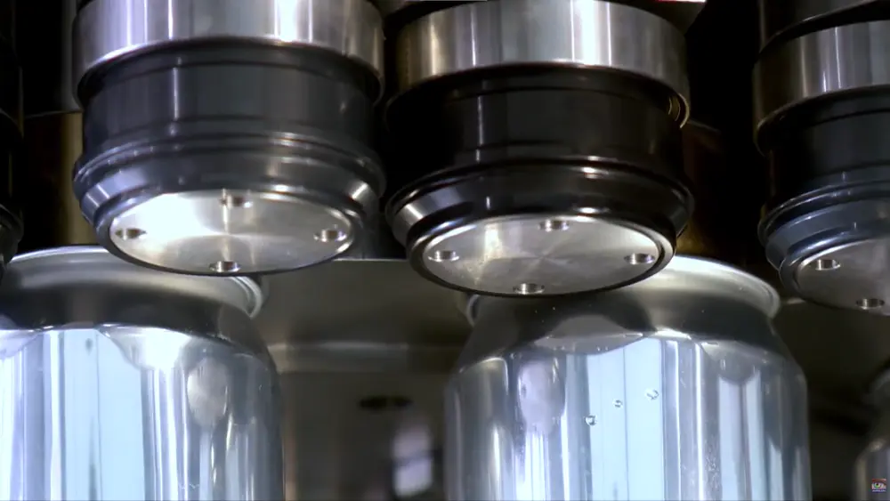 Componentes del cabezal de una máquina engargoladora que muestran el seaming chuck y los rodillos de primera y segunda operación